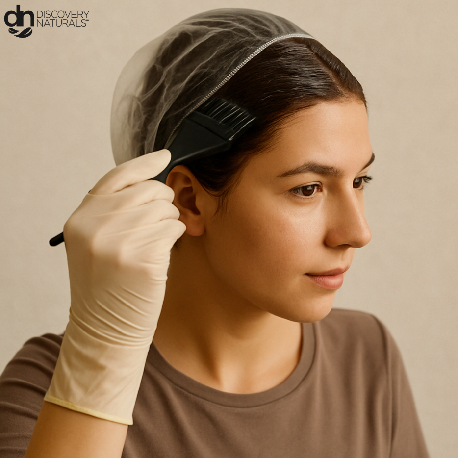 A woman applying Discovery Naturals hair color to her hair.